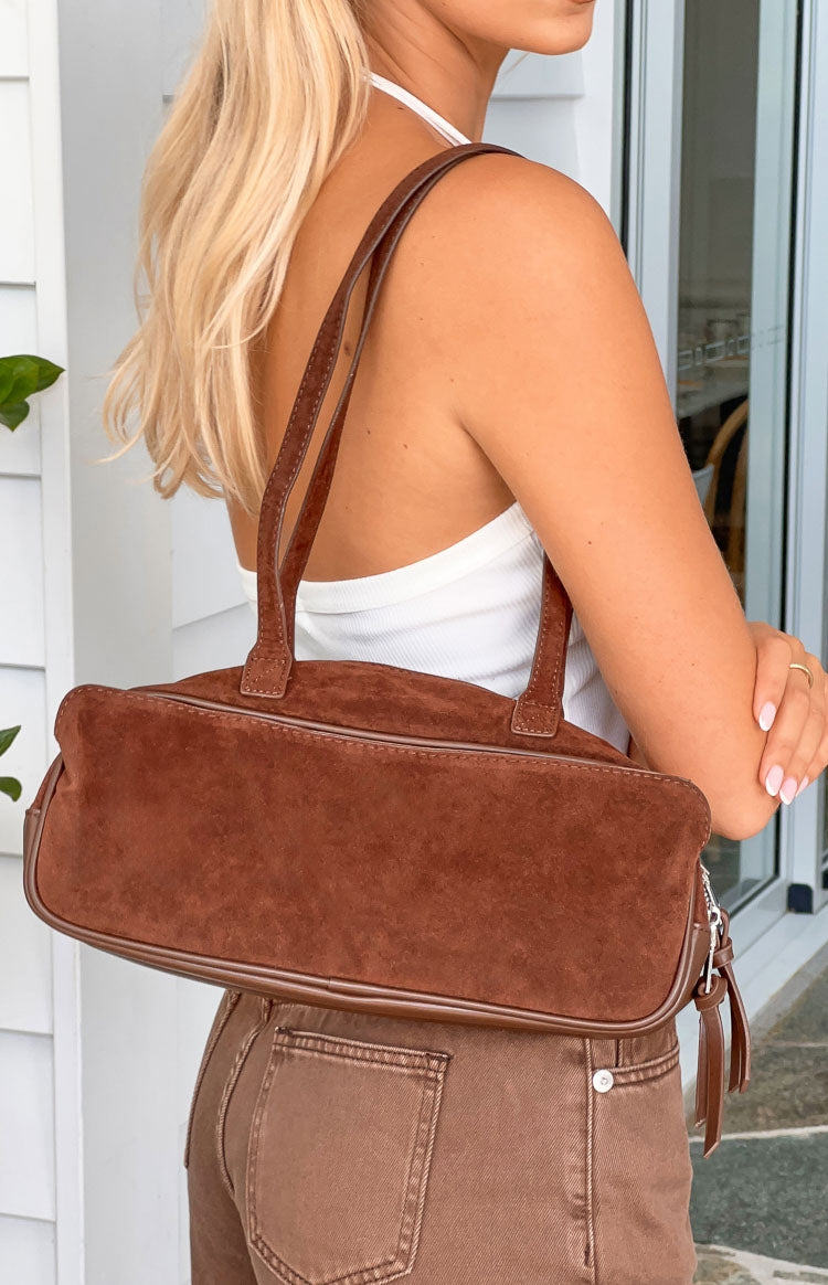 Beginning Boutique Sloane Brown Suede Baguette Bag brown suede baguette bag with twin shoulder straps and piping detail