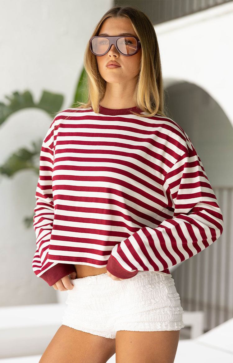 Cropped burgundy and white striped long sleeve top with a relaxed fit, burgundy crew neck and cuffs