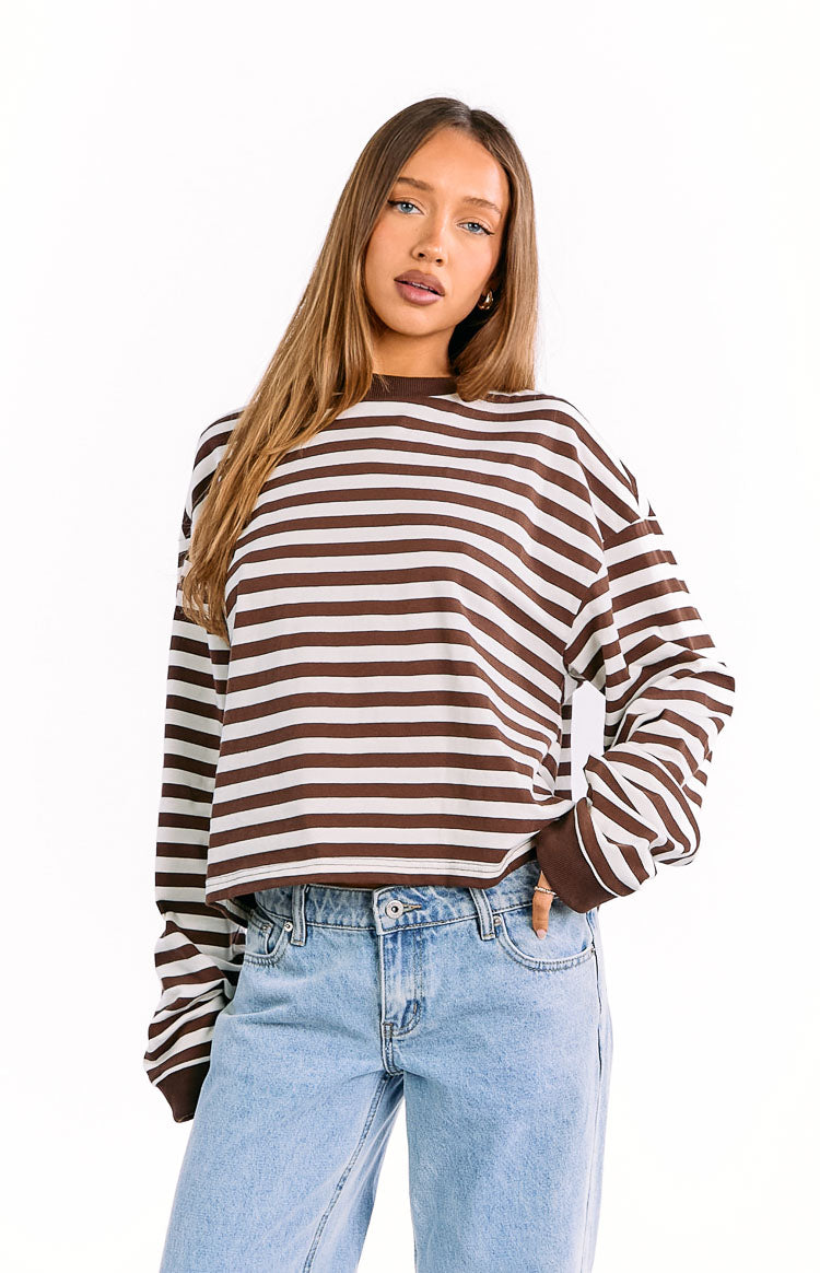 Chocolate brown and white horizontal striped long sleeve top with a crew neck, relaxed fit, and ribbed cuffs