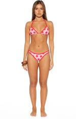 Pink and red polka dot triangle bikini top with red contrast binding, shown with matching bottoms