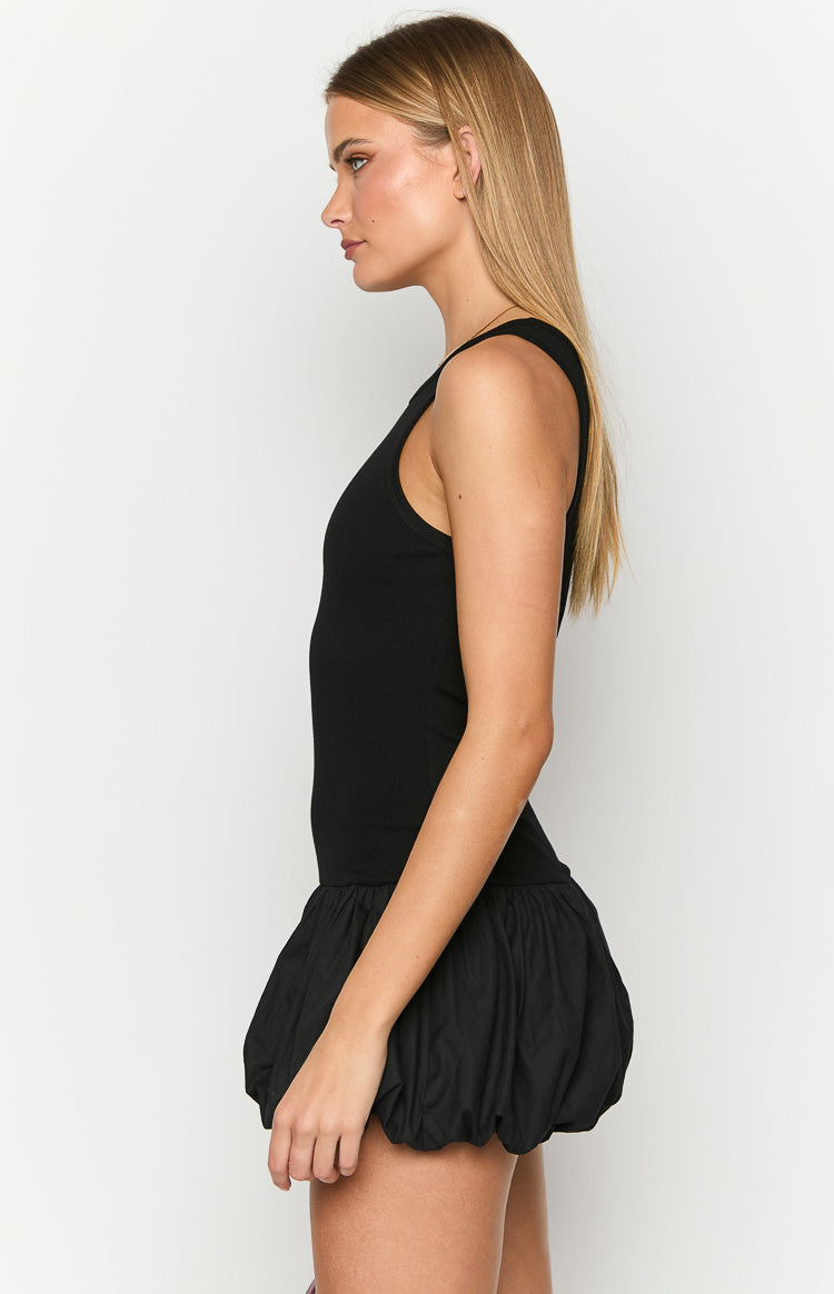 Side view of a black mini dress with a fitted tank top bodice and a voluminous bubble skirt