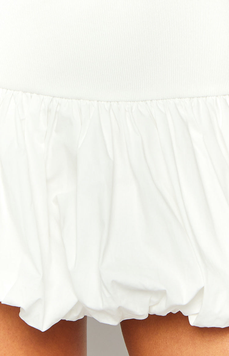Close-up of the white ribbed knit waistline and gathered voluminous bubble skirt