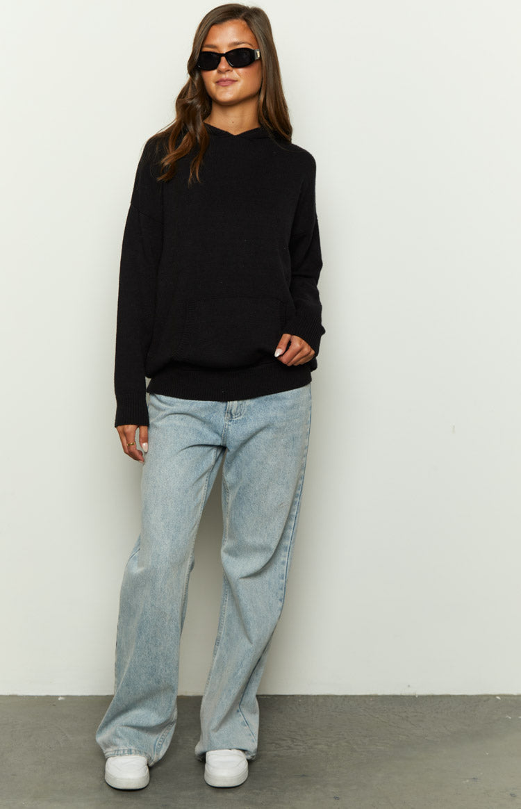 Black knitted hoodie with a relaxed fit, long sleeves, and a front kangaroo pocket