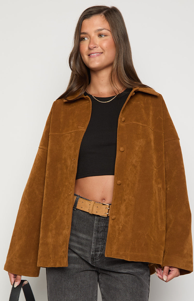 Front view of a tan suede oversized jacket, unbuttoned, showing the collared neckline and button-front placket