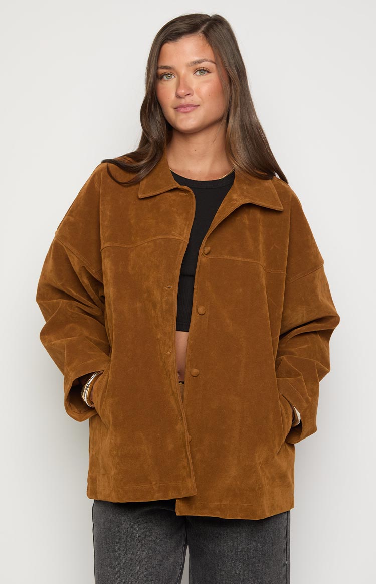 Front view of a tan suede oversized jacket with a classic collar, open button-front, and front patch pockets