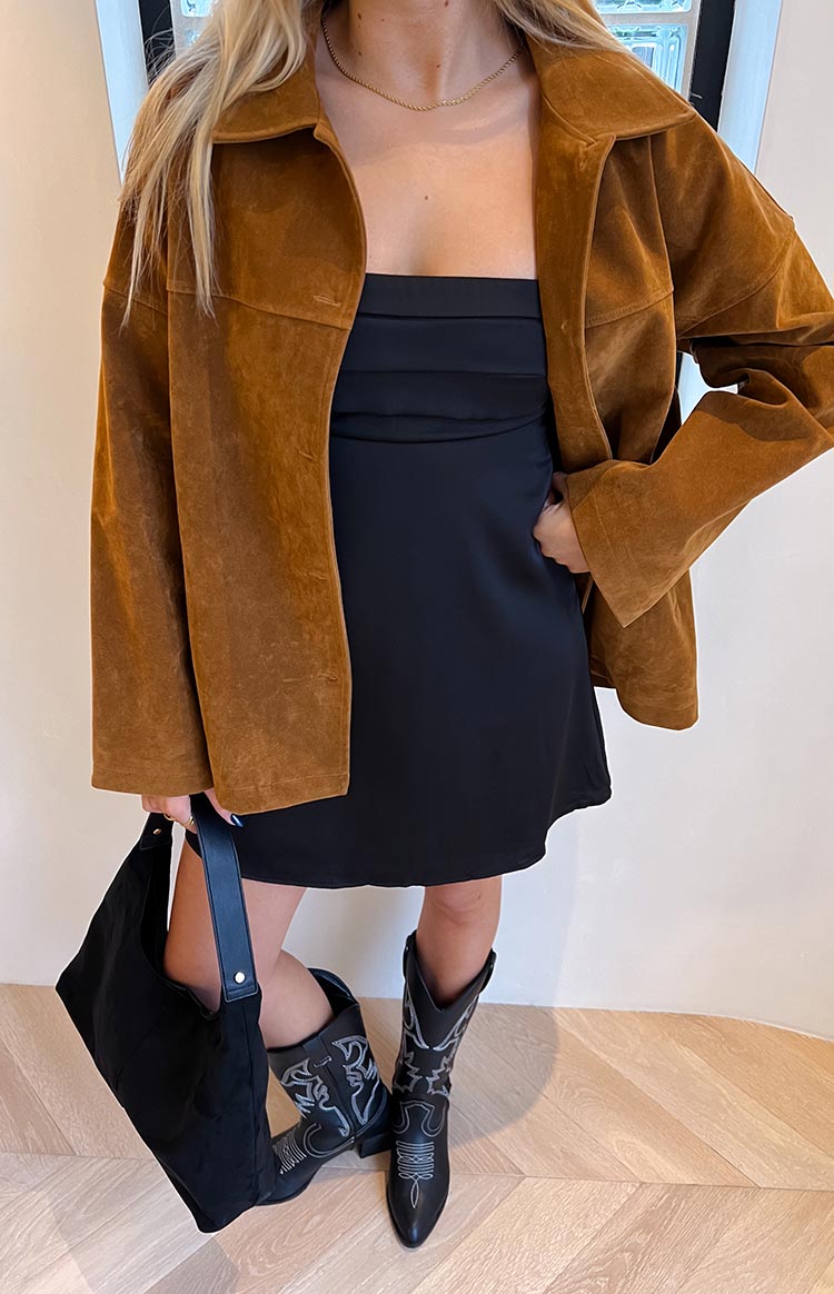 Front view of a tan suede oversized jacket worn open, showing the wide collar and relaxed fit