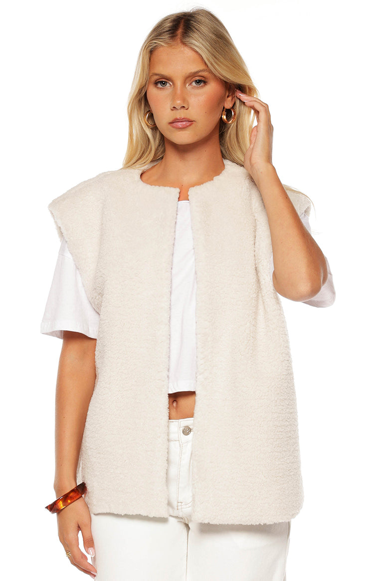 Cream teddy fleece vest with a round collarless neckline, cap sleeves, and an open front