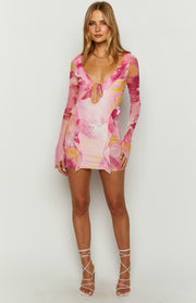 Pink floral mesh mini dress with a deep V-neck, tie-front detail, ruffled trim, and long flared sleeves