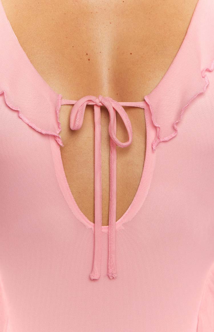 Close-up of the pink mesh V-neckline with a tie detail and ruffled trim