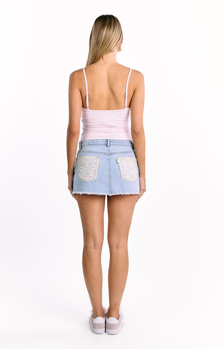 Rear view of a pink and white striped fitted top with thin adjustable spaghetti straps