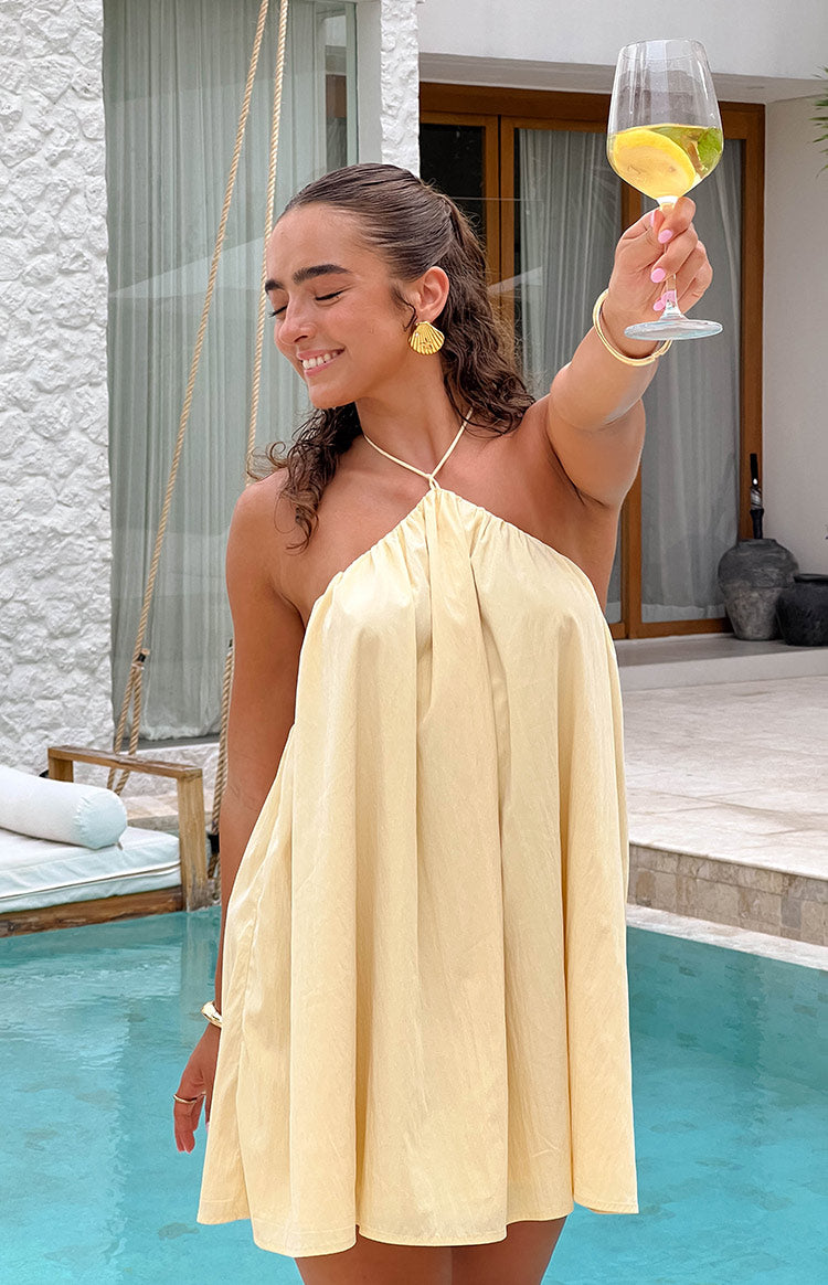 Beginning Boutique Talei Yellow Halter Puff Mini Dress light yellow gathered halter neck loose fit mini dress