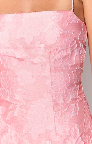 Close-up of the textured pink floral jacquard fabric with a vertical seam on the mini dress