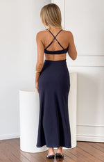 Rear view of a navy crepe maxi dress with criss-cross adjustable spaghetti straps and a cut-out back