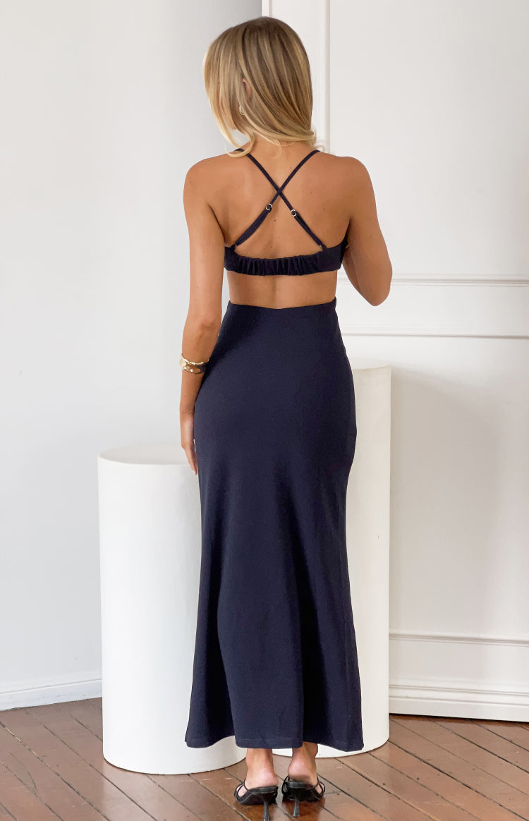 Rear view of a navy crepe maxi dress with criss-cross adjustable spaghetti straps and a cut-out back