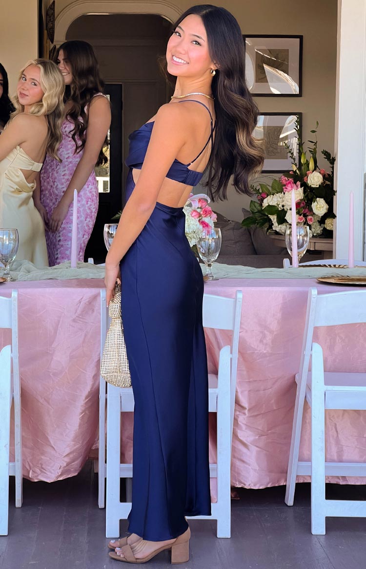Beginning Boutique Taleah Navy Formal Maxi Dress navy satin cowl neck maxi dress with side cutouts and criss-cross back straps