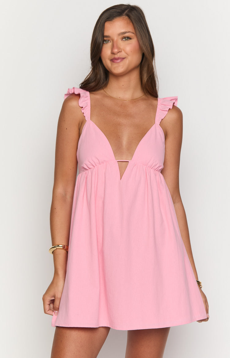 Close-up front view of a pink mini dress with a deep V-neck, bust cutout, and ruffled straps