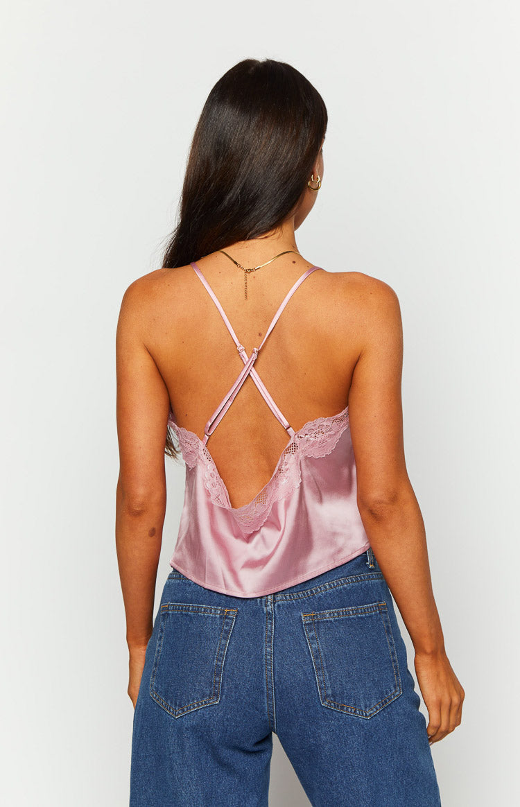 Rear view of a pink satin cami top with criss-cross adjustable spaghetti straps and a low scoop back with lace trim