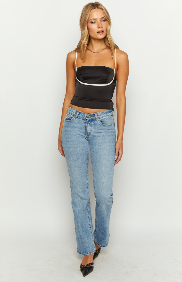 Black satin crop top with white piping detail and thin spaghetti straps