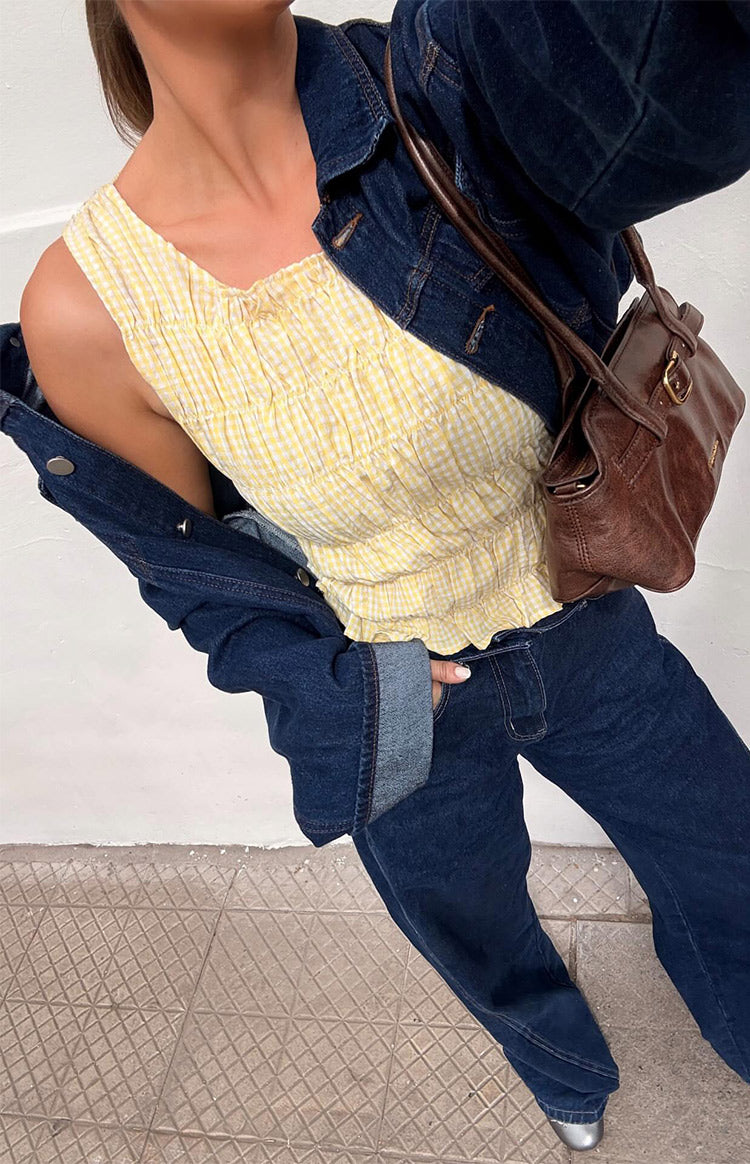 Yellow and white gingham top with a square neckline, shirred bodice, and ruffled hem