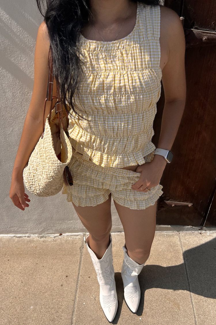 Yellow and white small gingham shorts with multiple tiered ruffles and a relaxed fit
