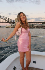 Fitted pink sequin mini dress with a straight neckline and thin spaghetti straps