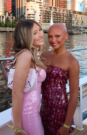 Front view of a fitted pink sequin strapless mini dress with a straight neckline
