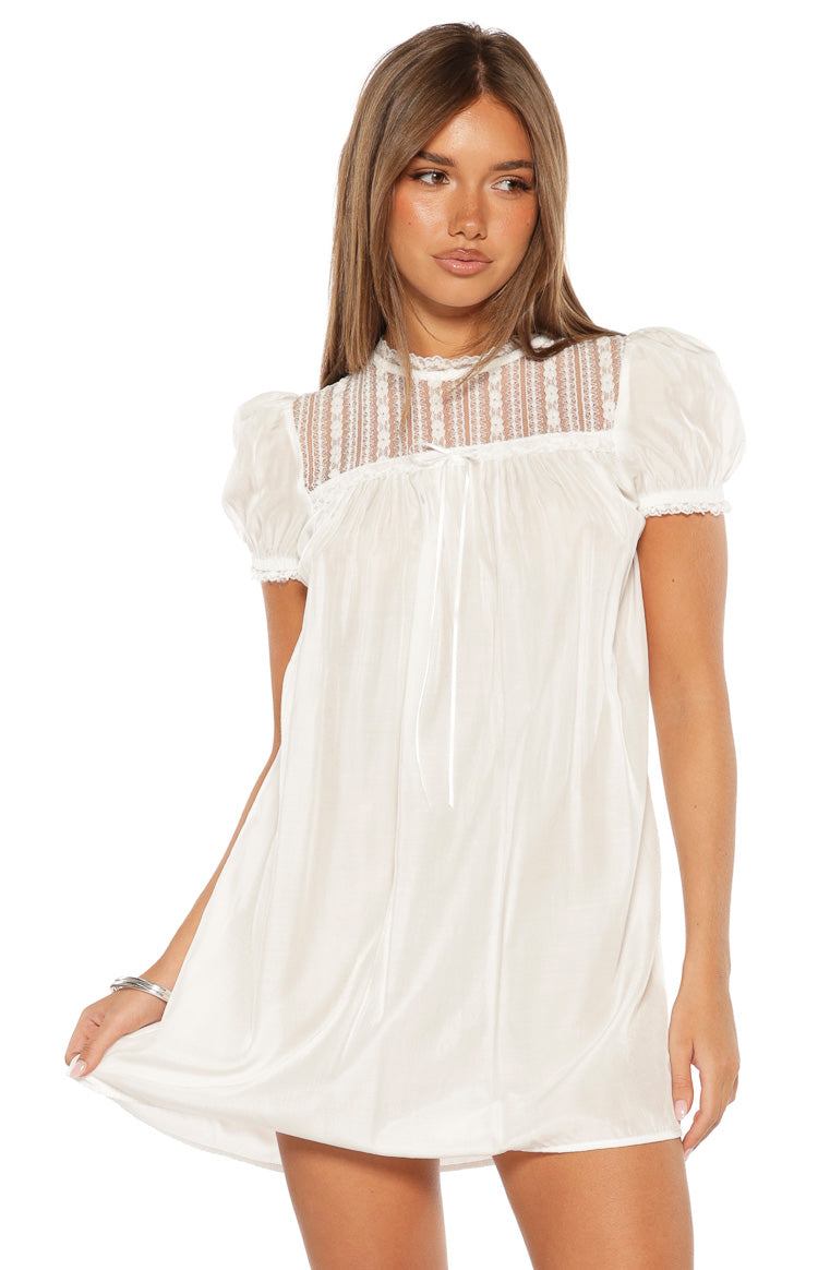 White sheer lace high neck mini dress with puff sleeves and a tie-front detail