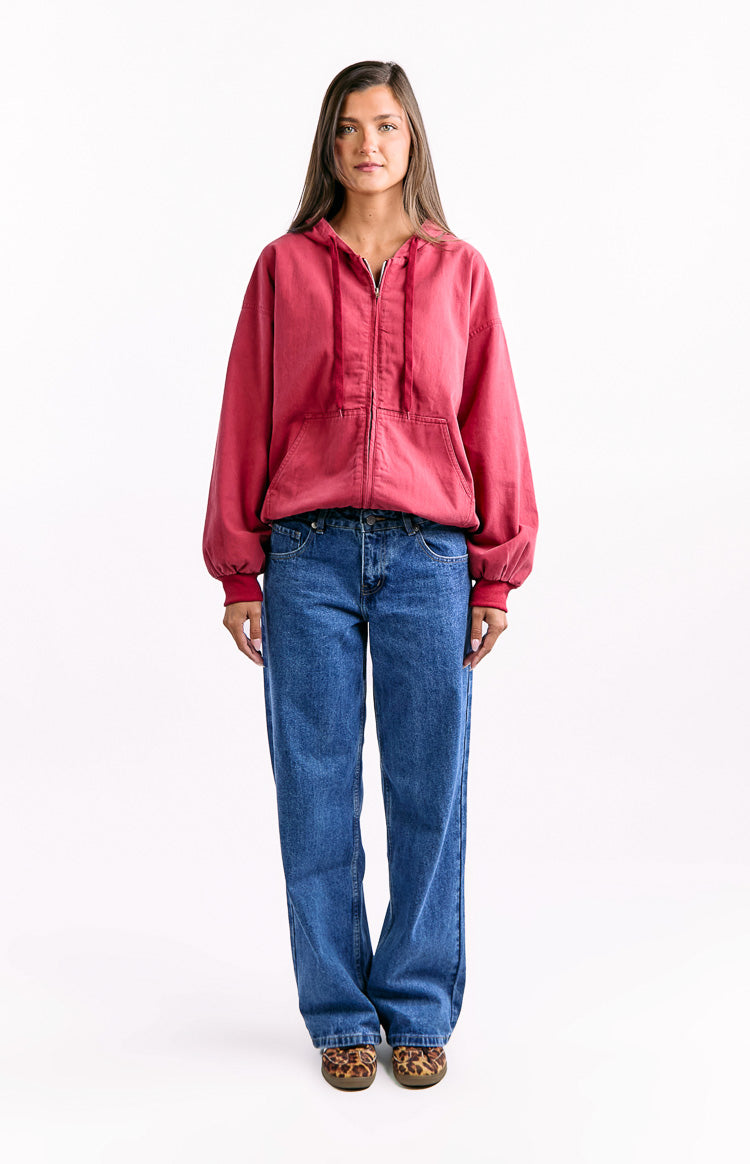 Front view of a washed red oversized hooded jacket with a full zipper and front pockets