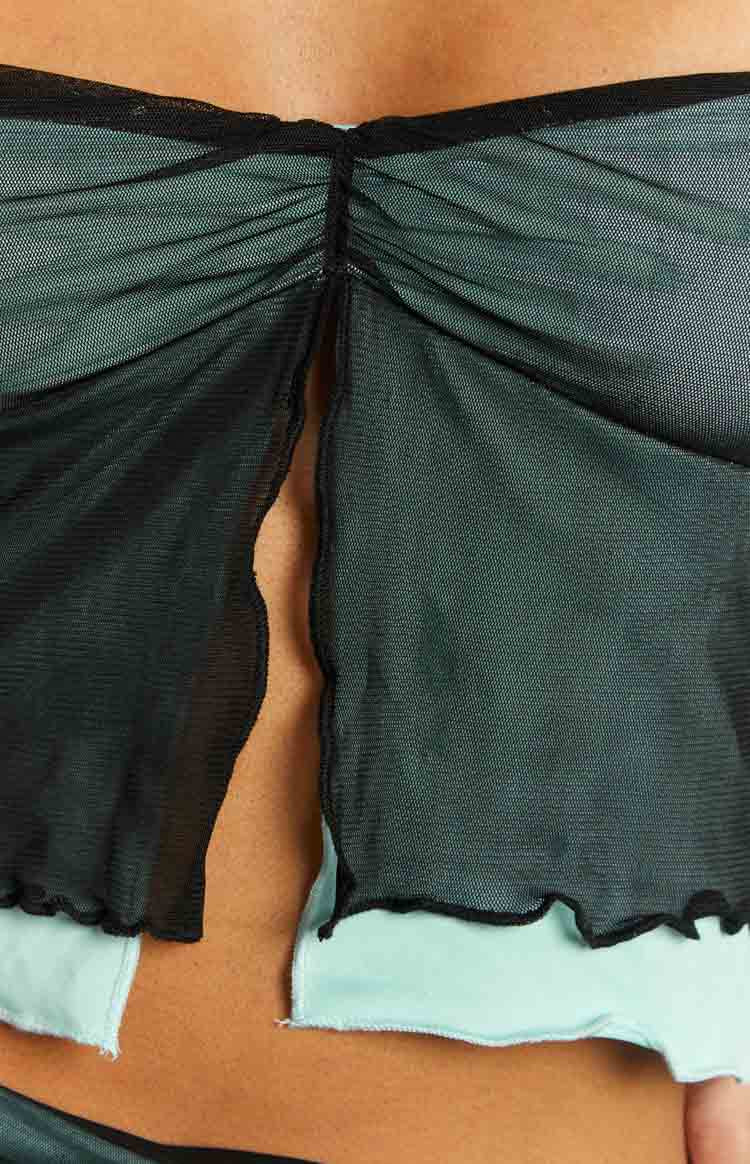 Close-up of the ruched center back seam of a black mesh top with a light blue contrast lining
