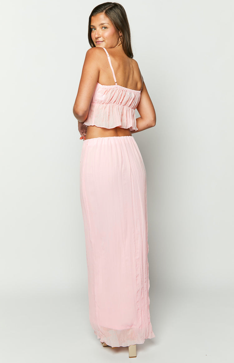 Rear view of a light pink crinkled maxi skirt showing the elasticated waistband and flowy drape