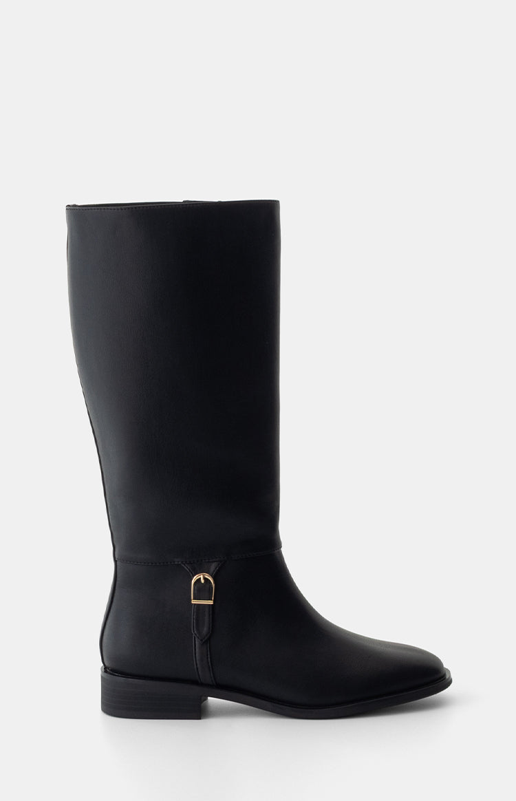Side view of a black PU riding boot with a gold buckle strap detail and low block heel