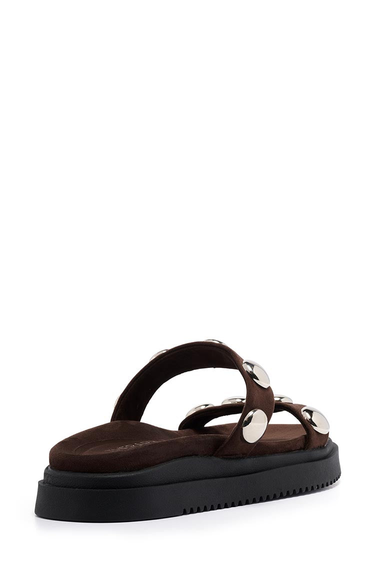 Side view of chocolate suede platform sandals with two studded straps and a chunky black ridged sole
