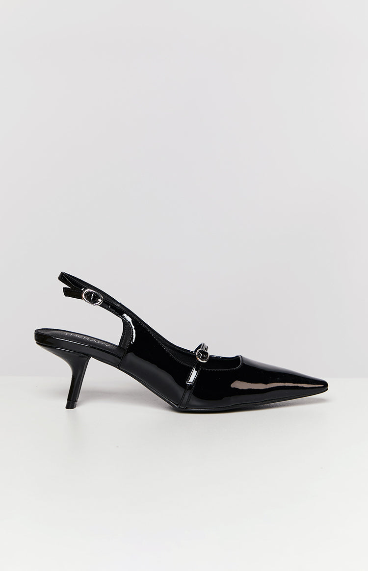 Side view of a black patent slingback heel with a pointed toe, kitten heel, and buckled vamp strap