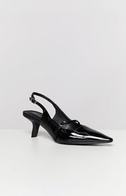 Side view of a black patent slingback heel with a pointed toe, low kitten heel, and Mary Jane strap
