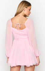 Rear view of a pink long sleeve mini dress with a square back neckline and self-tie detail