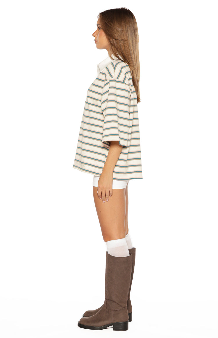 Side view of the oversized green stripe polo shirt with drop shoulders and a white collar