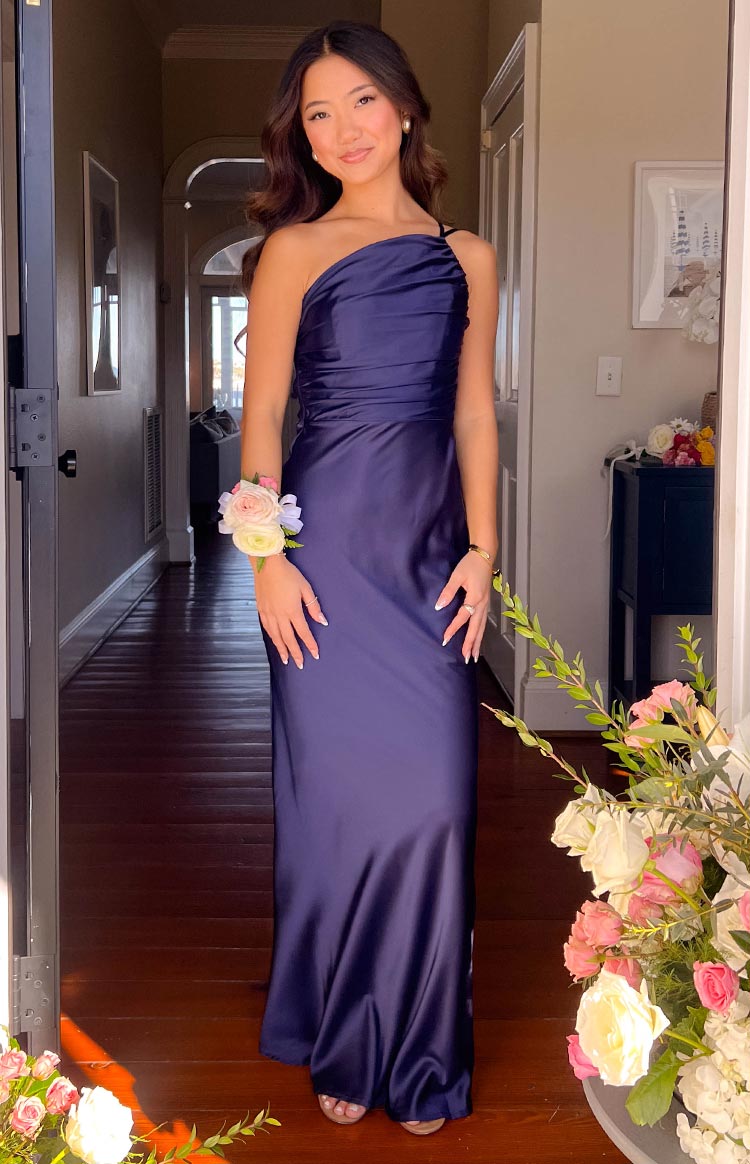 Navy satin one-shoulder formal maxi dress with draped bodice and flowing skirt