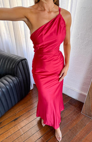 Red one-shoulder maxi dress with a draped neckline, ruched bodice, and a long, flowing skirt