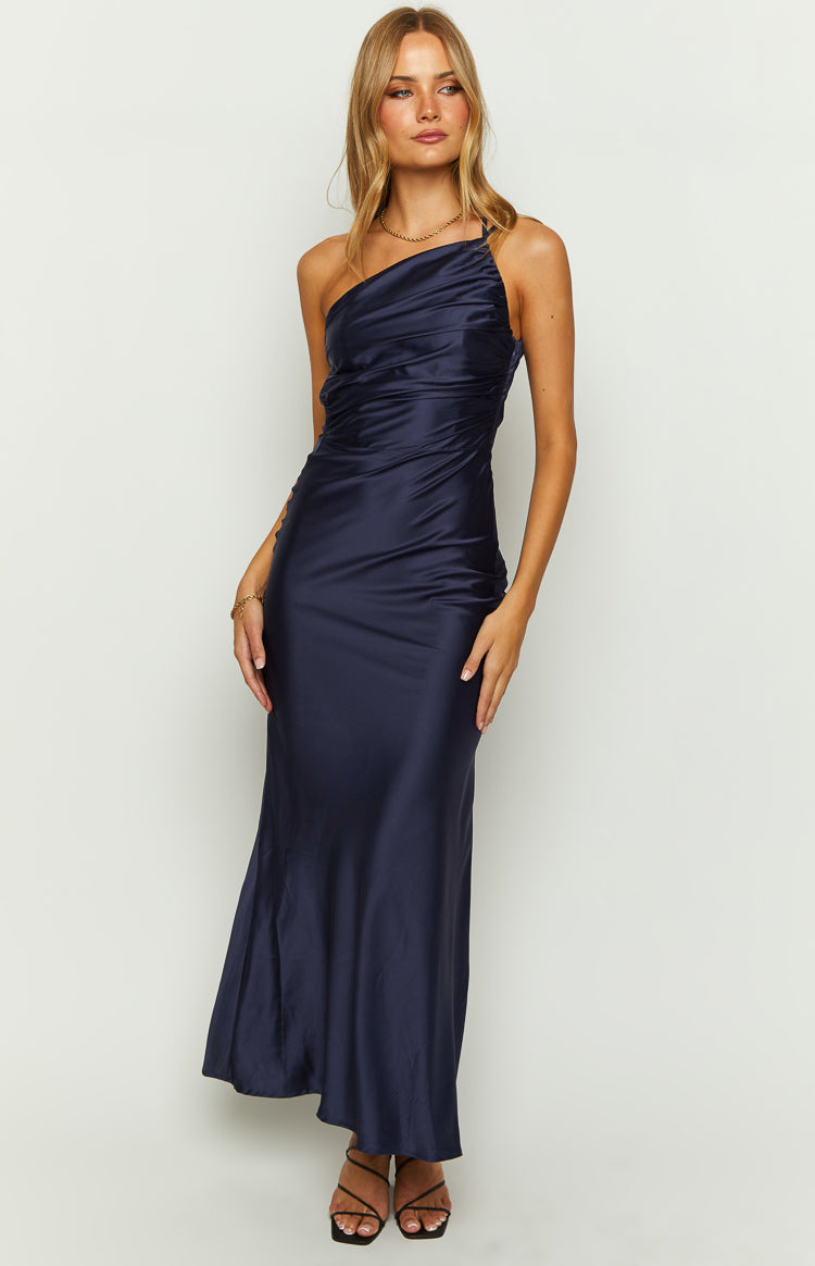 Front view of a navy satin maxi dress featuring a one-shoulder neckline and ruched detailing on the bodice