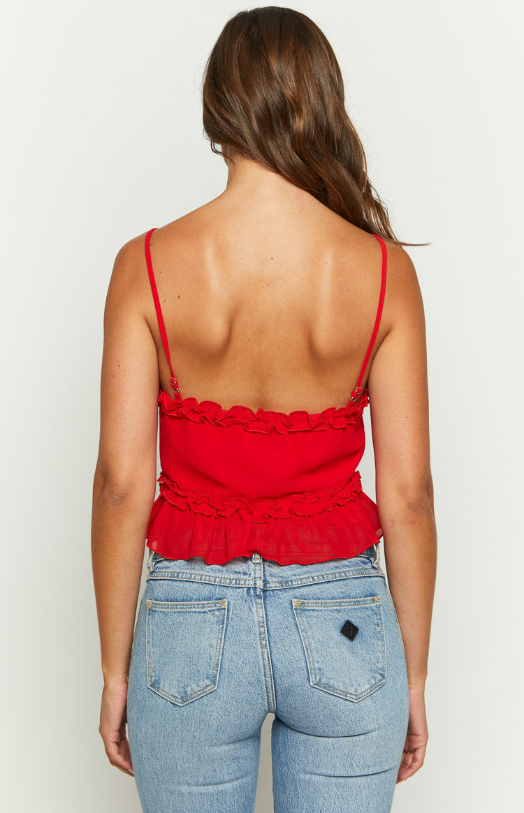 Back view of a red cami with thin adjustable spaghetti straps and two tiers of ruffles along the hem