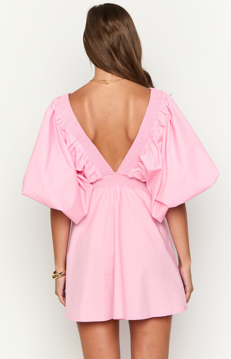 Back of a pink mini dress showing the deep V-neck, shirred trim, and voluminous short sleeves