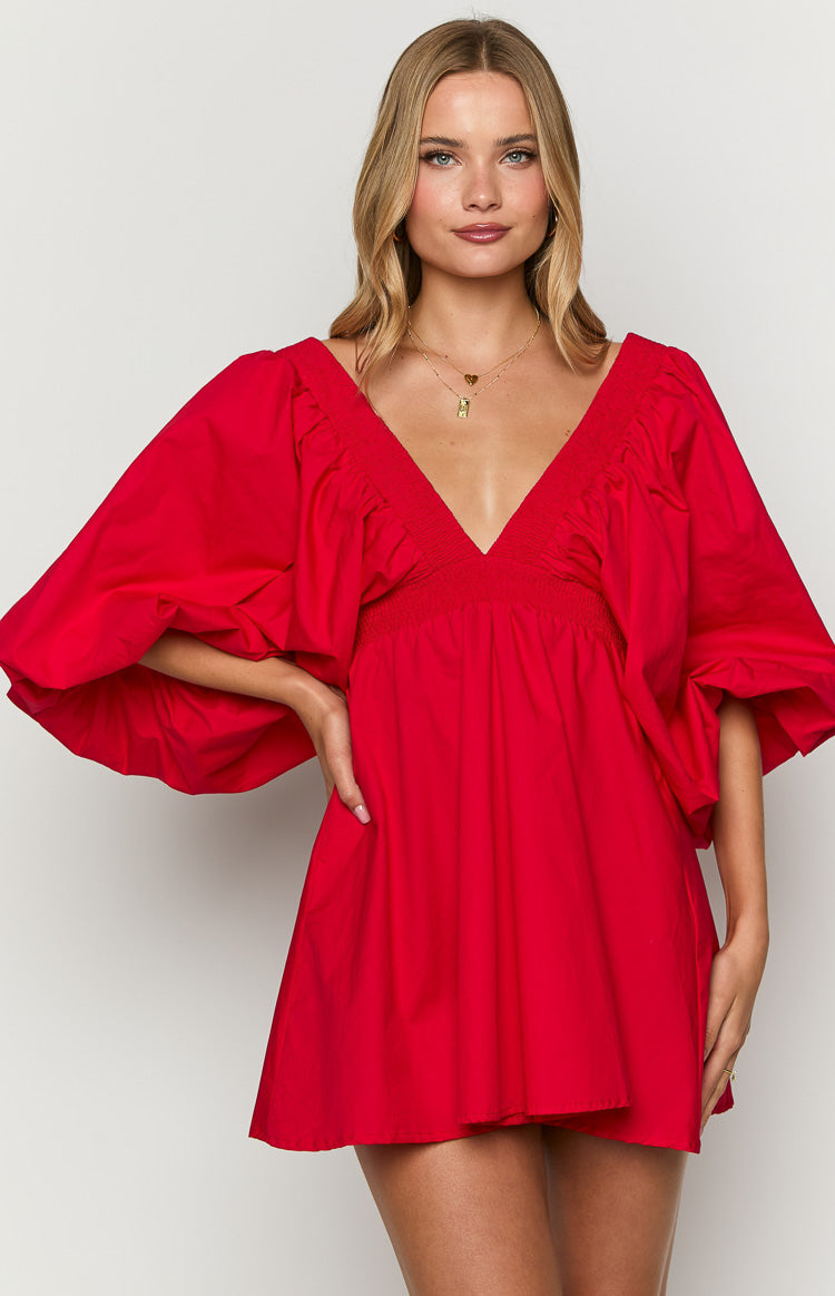 Red mini dress with a deep V-neckline, smocked bodice, and voluminous puff sleeves