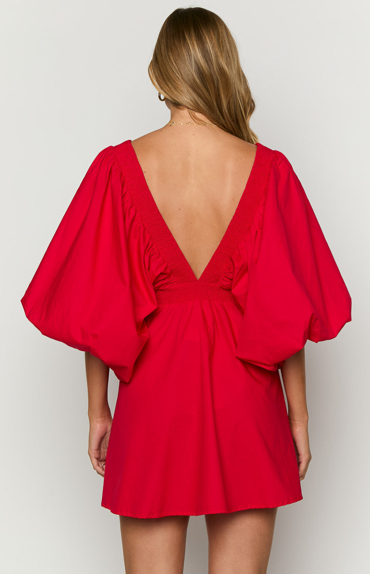 Rear view of a red mini dress with a deep V-back, shirred detailing, and voluminous puff sleeves
