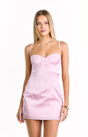 Front view of a light pink satin mini dress with a structured bustier bodice and delicate lace trim
