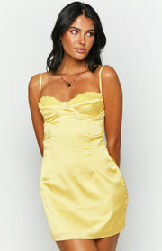 Close-up of the yellow satin mini dress showing the bustier bodice with lace trim and spaghetti straps