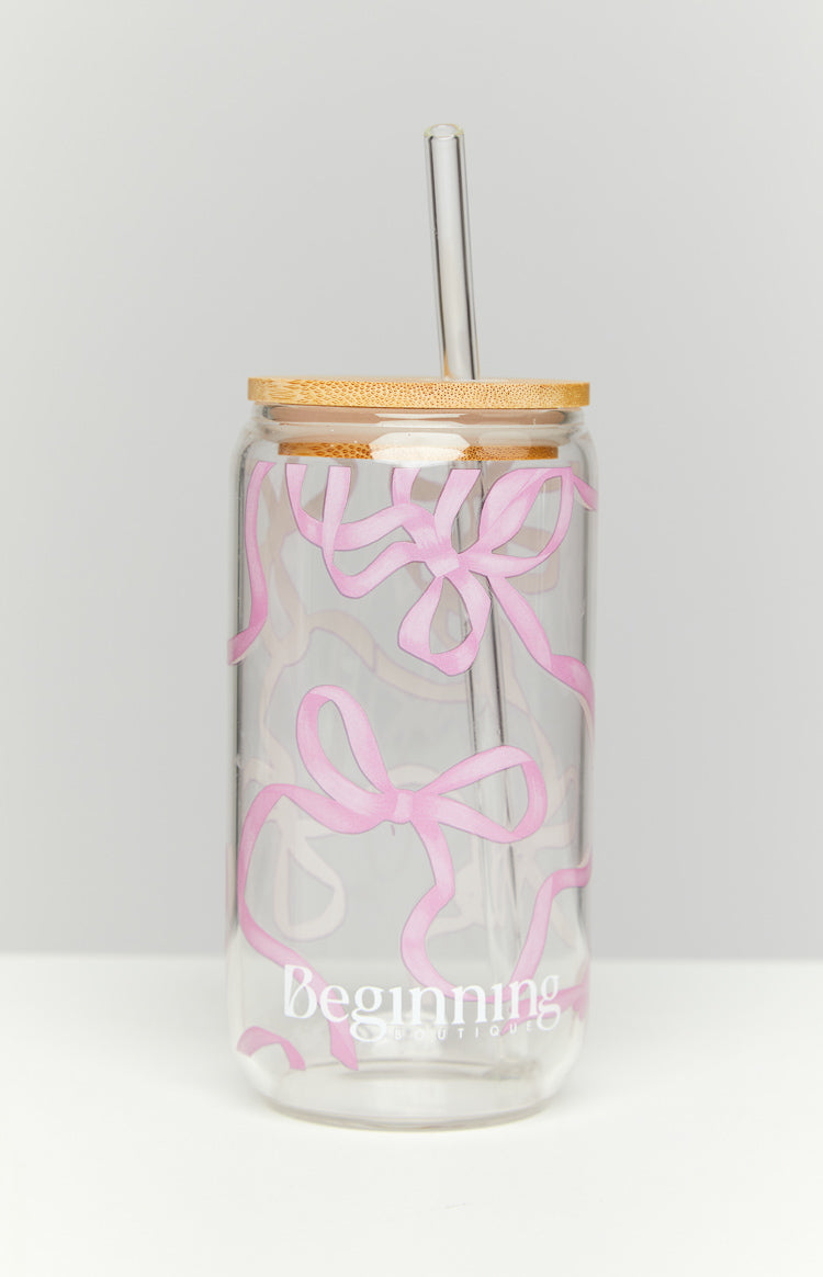 Clear glass tumbler with a scattered pattern of various sized bright pink bows and ribbons