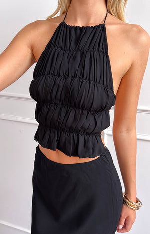 Beginning Boutique Uma Black Crop Top black halter neck crop top with horizontal ruching and a ruffled hem