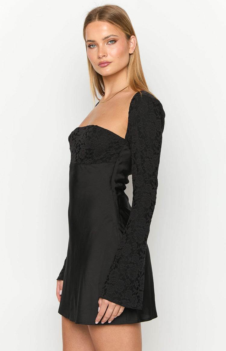 Side view of a black mini dress with a square neckline, lace bust detail, and long flared lace sleeves
