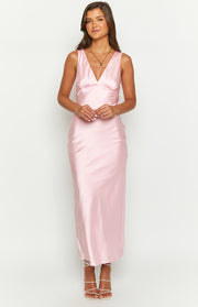 Front view of a light pink satin maxi dress with a V-neck, fitted ruched bust, and a flowing skirt