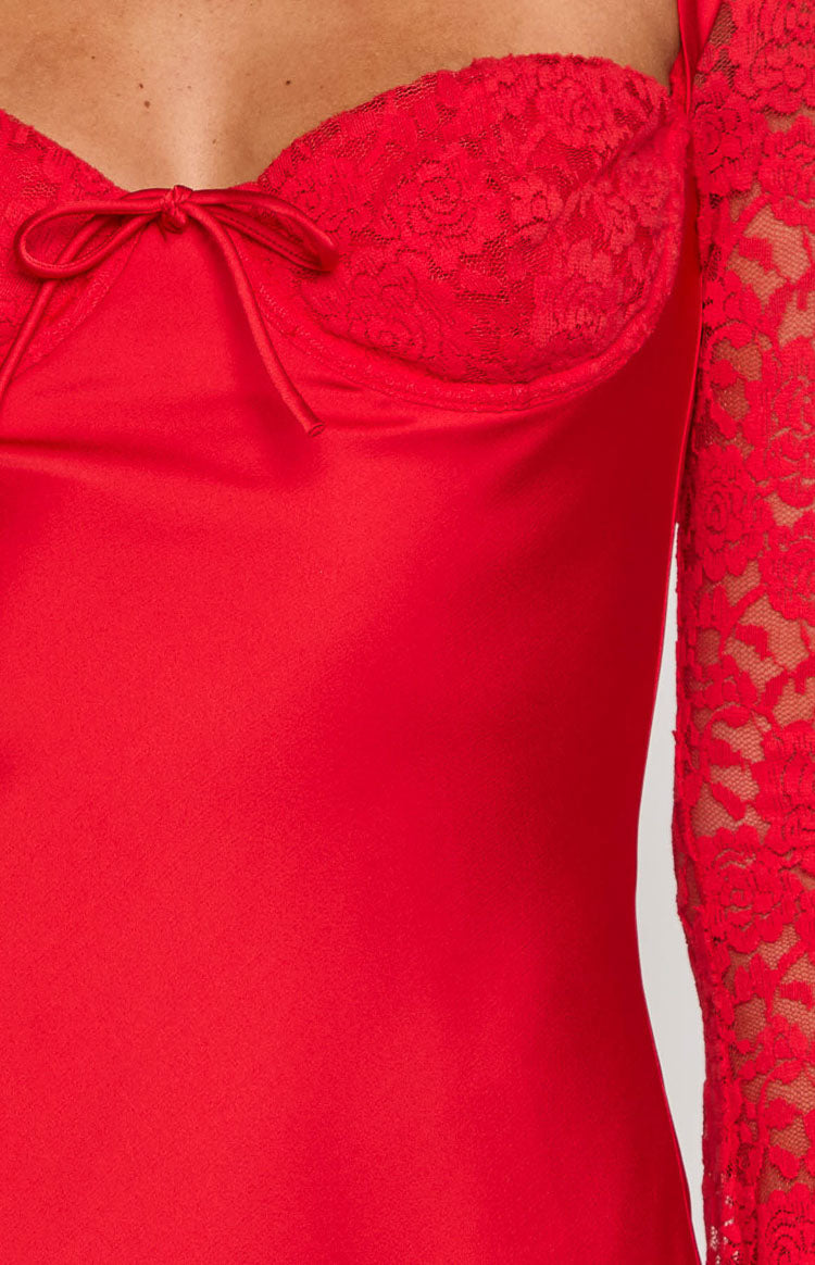 Close-up of the red lace bust cups with a tie-front detail and the sheer lace long sleeve of the mini dress